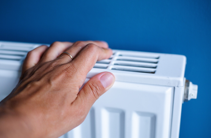 Lady with hand on the radiator 